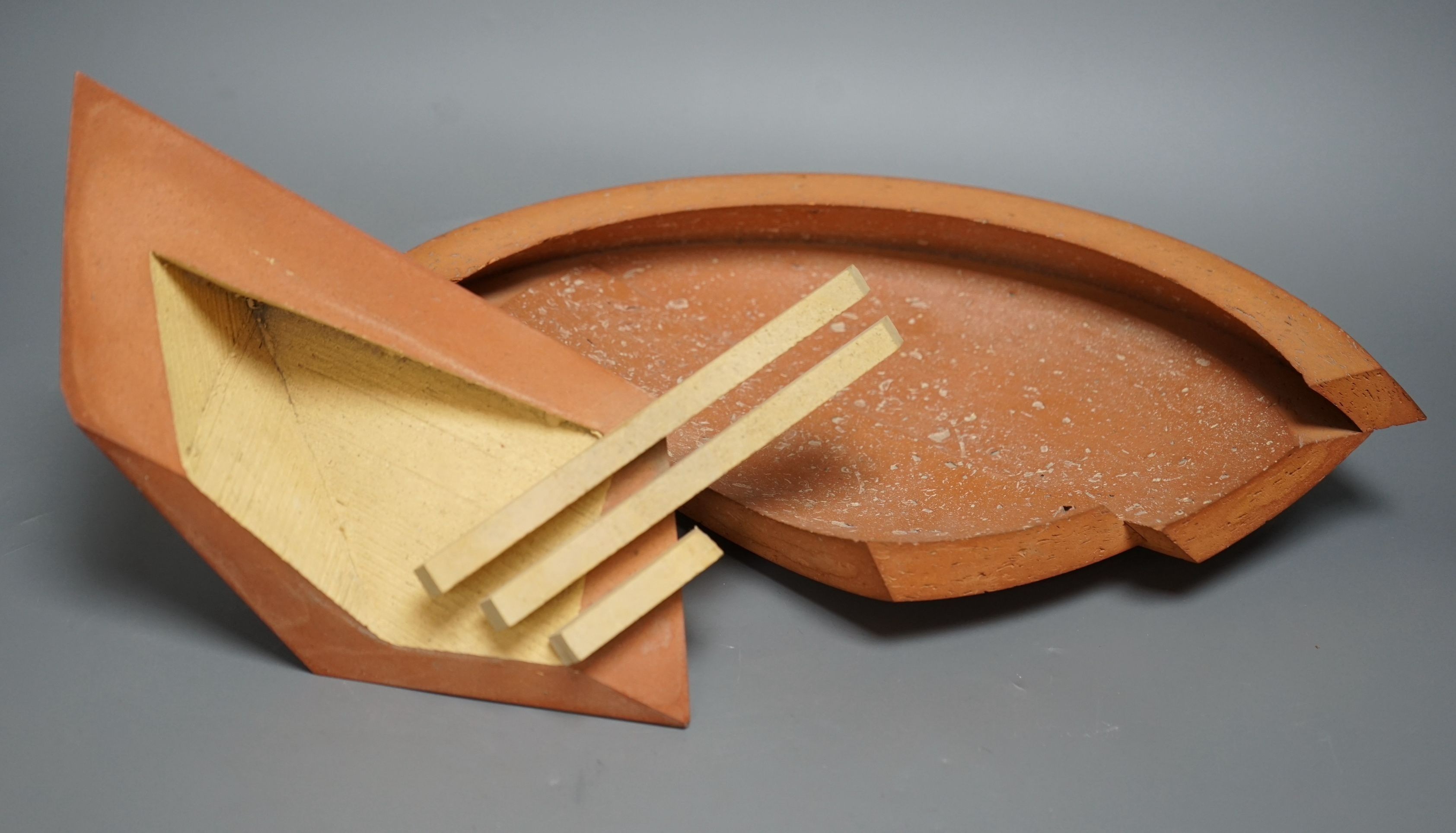 Martin Smith (b.1950), two disk forms, redware, one damaged, with original purchase receipt, largest 37cm wide (2)